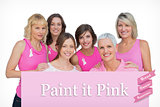 Composite image of happy women posing and wearing pink for breast cancer
