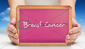 Composite image of females hands showing pink board