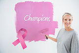 Composite image of happy young woman painting her wall pink