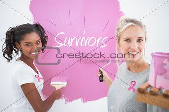 Composite image of smiling housemates painting wall pink