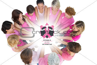 Composite image of cheerful women joined in a circle wearing pink for breast cancer