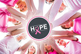 Composite image of diverse women smiling in circle wearing pink for breast cancer