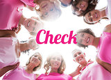 Happy women smiling in circle wearing pink for breast cancer
