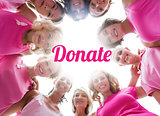Cheerful women smiling in circle wearing pink for breast cancer