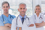 Composite image of group of doctor and nurses standing together