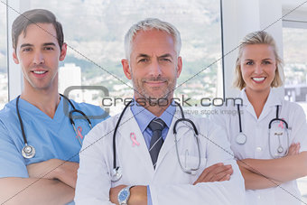 Composite image of group of doctor and nurses standing together