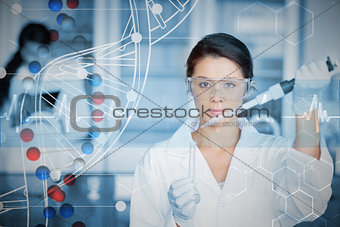 Composite image of serious chemist working with white dna helix diagram inteface
