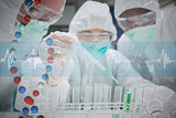 Composite image of chemist adding green liquid to test tubes as two others are watching