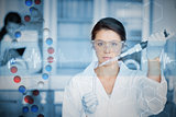 Composite image of serious chemist working with large pipette and test tube