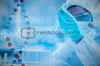 Composite image of protected scientist looking at a dangerous liquid in test tubes