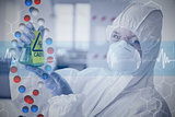 Composite image of scientist in protective suit with hazardous chemical in flask