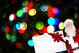 Santa claus showing a card