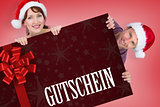 Composite image of couple both wearing santa hats