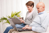 mature couple using mobile devices