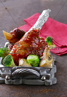Meat shin baked with tomato sauce with vegetables garnish