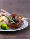 homemade meat sausages with vegetables garnish (broccoli and mushrooms)