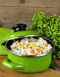 garnish rice with various vegetables (carrots, corn and green peas)