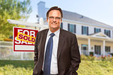 Real Estate Agent in Front of Sold Sign and House