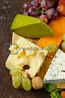 cheeseboard with different types of cheese and grapes