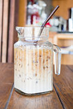 Iced coffee latte serving in glass pitcher