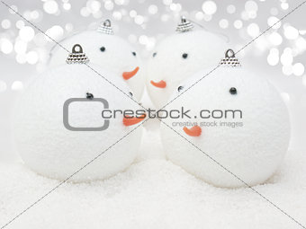 Cute Snowman baubles in snow