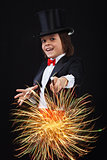 Young magician boy using his magic wand