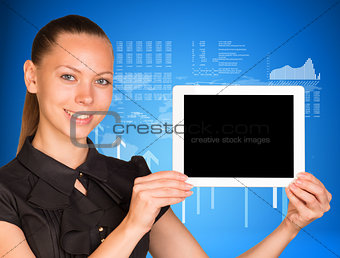 Beautiful businesswoman in dress holding tablet pc. Arrows and figures as backdrop