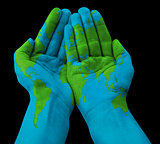 World map painted on human hands
