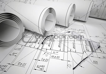 Scrolls of engineering drawings and glasses on drawing