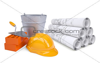 Scrolls of architectural drawings and work tools with helmet