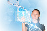 Beautiful businesswoman in dress presses finger on model of DNA