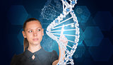 Beautiful businesswoman in dress presses finger on model of DNA