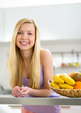 Portrait of smiling young woman in modern kitchen