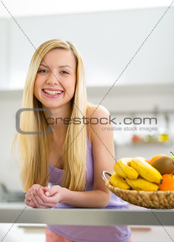 Portrait of smiling young woman in modern kitchen