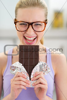 Portrait of happy young woman with chocolate