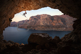 Female rock climber on a cliff in a cave at Kalymnos