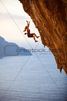 Female rock climber falling of a cliff while lead climbing