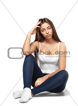 beautiful girl sitting on a white background isolated