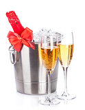 Two champagne glasses and bottle in cooler