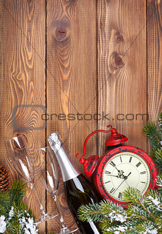Christmas background with clock, snow fir tree and champagne