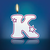 Candle letter K with flame