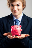 Holding a piggy bank
