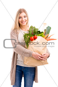 Beautiful woman carrying vegetables