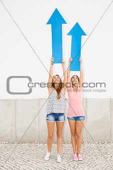 Teenagers pointing blue arrows