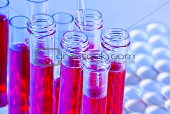 detail of pipette and test tubes with red liquid in laboratory 