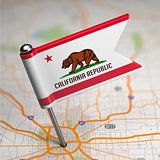 California Small Flag on a Map Background.