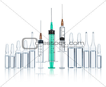 syringes with needles and medical ampoules on an isolated white 