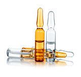 transparent and yellow medical ampoules on an isolated white bac