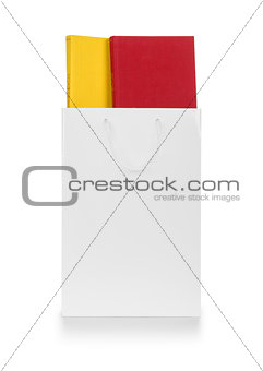 white gift bag with books on an isolated white background