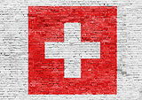 Flag of Switzerland over brick wall